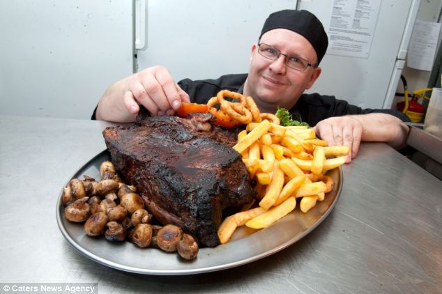 Monstrous: Chef Jurgen Koller dishes up a 150oz steak, complete with chips and onion rings for brave diners at the The Duck Inn in Redditch, Worcestershire