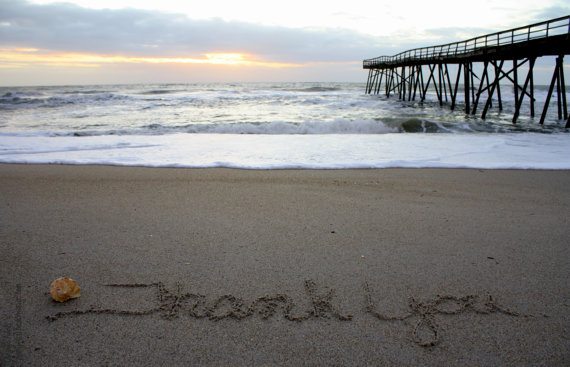 Thank you written on beach