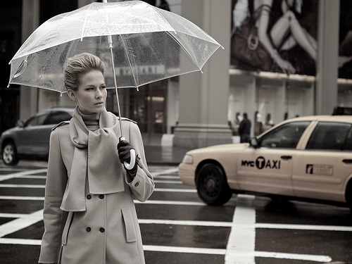 model with umbrella and New York taxi