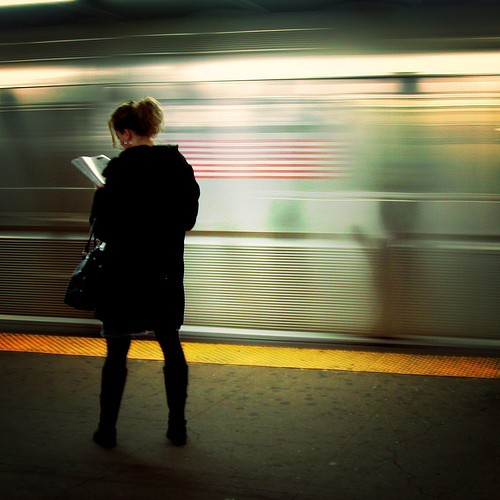 woman reading New York subway